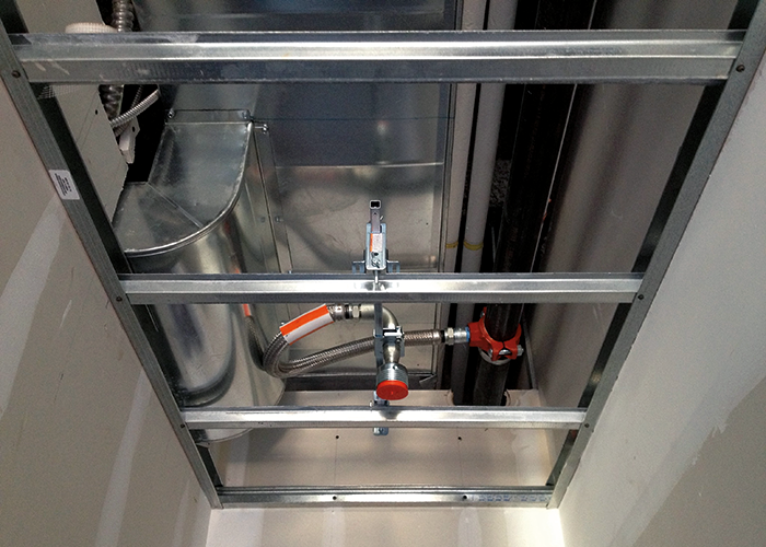 Flexible drop installed in crowded ceiling space.