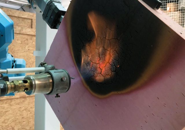 Image 1: Protective char forms as phenolic insulation is exposed to fire from blow torch.