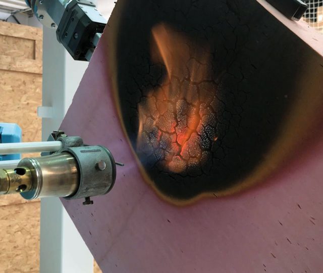 Image 1: Protective char forms as phenolic insulation is exposed to fire from blow torch.