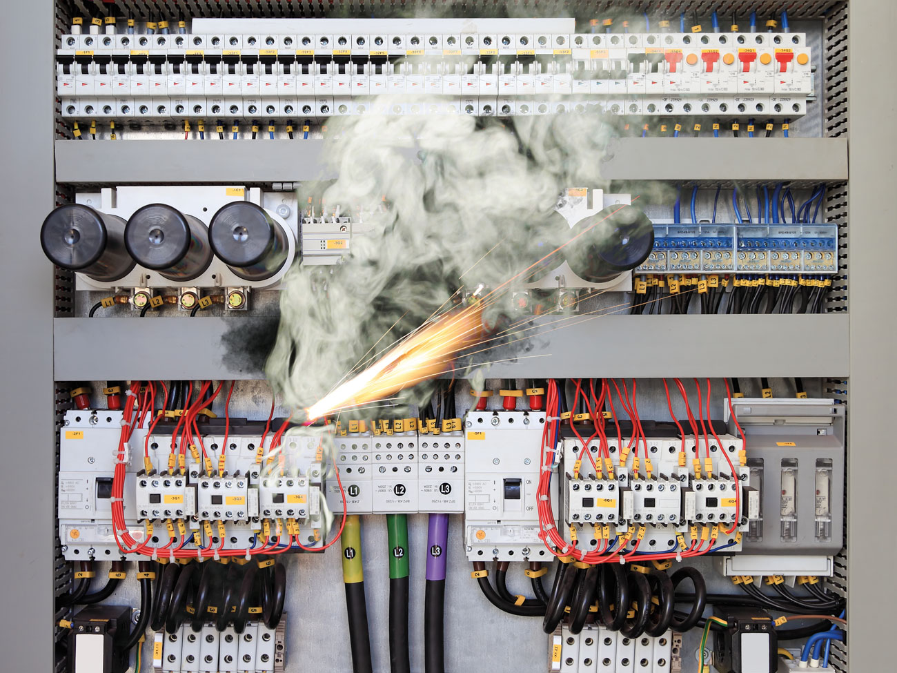 Overloaded electrical circuit causes electrical short and fire.