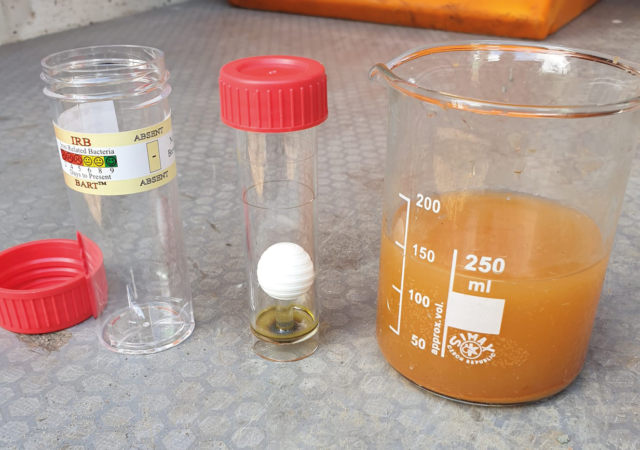 Photo shows the test vial (centre) once it has been removed from the outer dispenser.