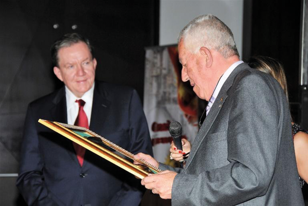 Mr. Moncada receiving a lifetime award from Jim Shannon, President of NFPA, during OPCI's 30th anniversary in Bogota.