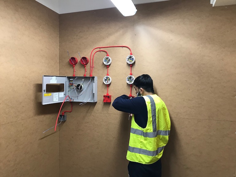 JTL Apprentice working on a Kentec Fire Panel. (Image copyright: JTL)