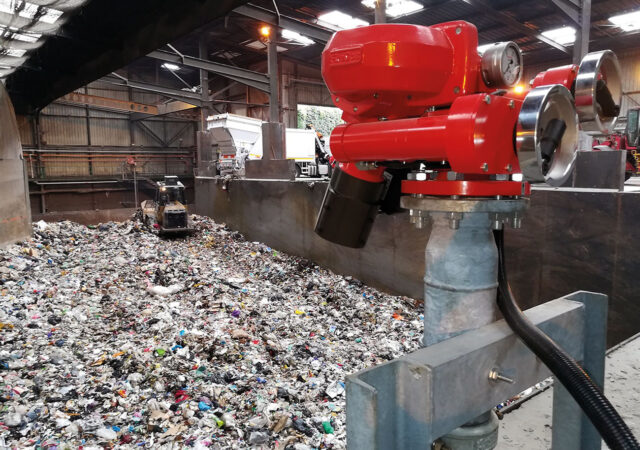 Figure 1: Remote controlled FireDos M2 fire monitor with manual backup on standby in recycling facility.