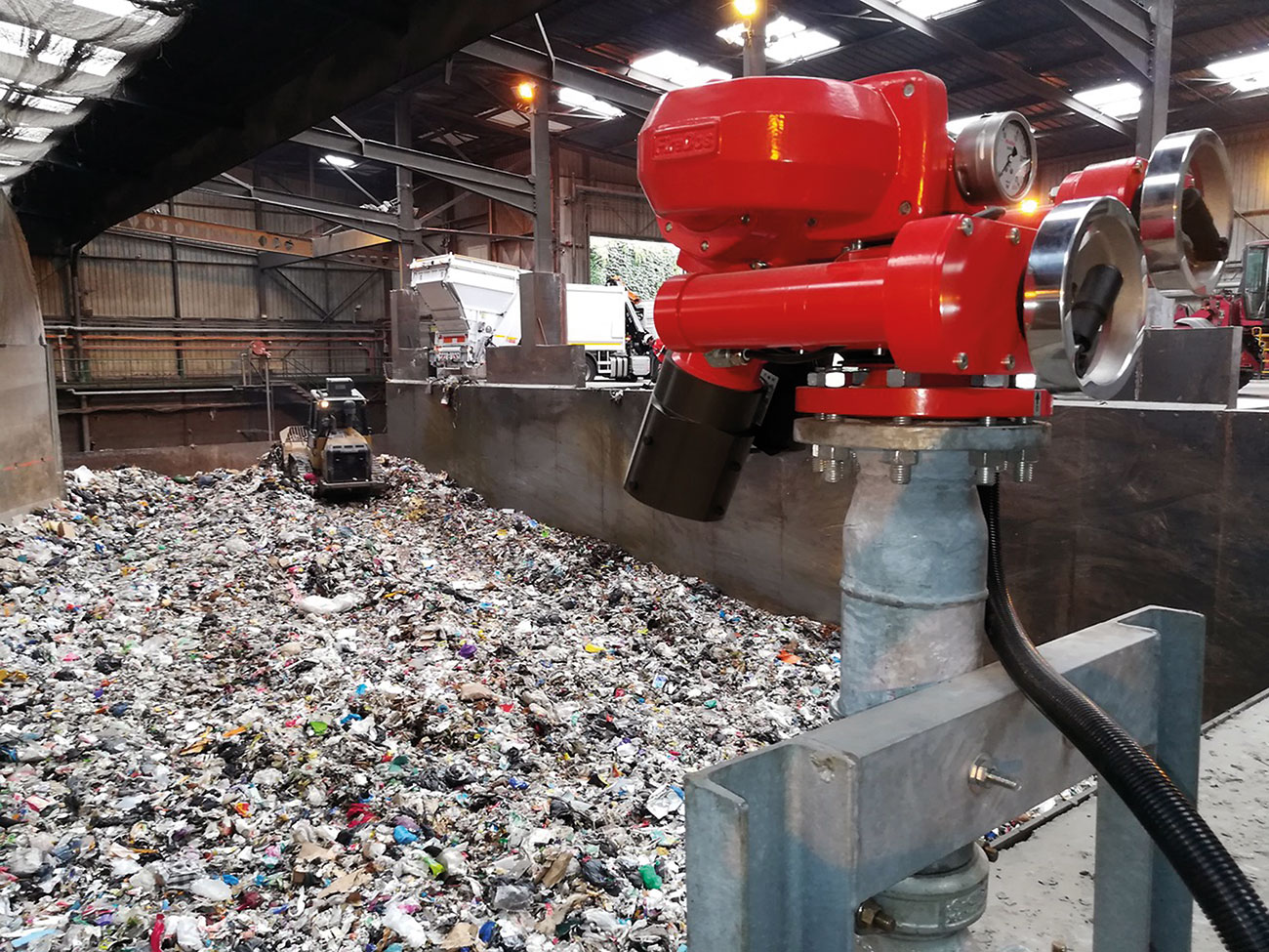 Figure 1: Remote controlled FireDos M2 fire monitor with manual backup on standby in recycling facility.