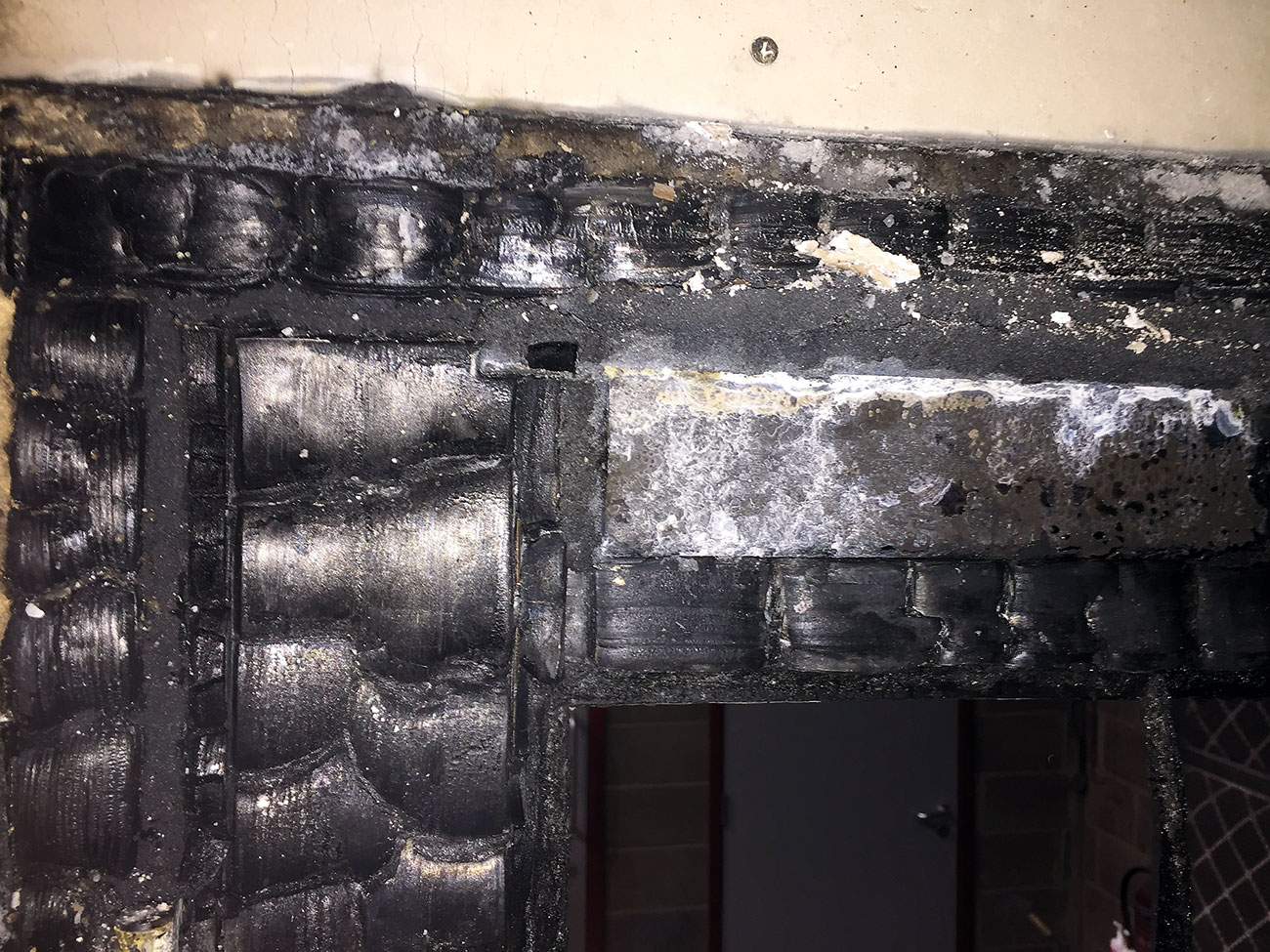 Expanded graphite packed between the door frame and door stile as well as to the head of the door.