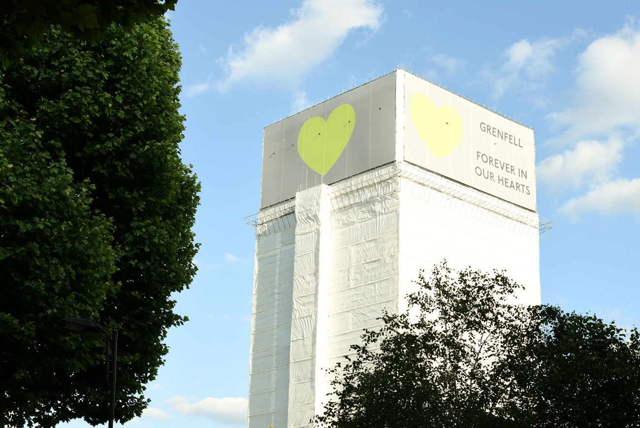 A view of the polythene-wrapped burnt husk of the Grenfell Tower, one year after the deadly fire which killed 72 people.